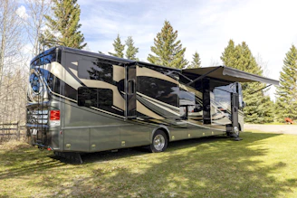 a motor home parked in a grassy field