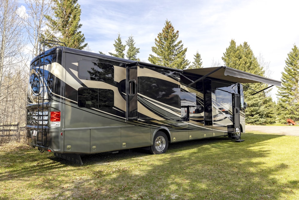 a motor home parked in a grassy field