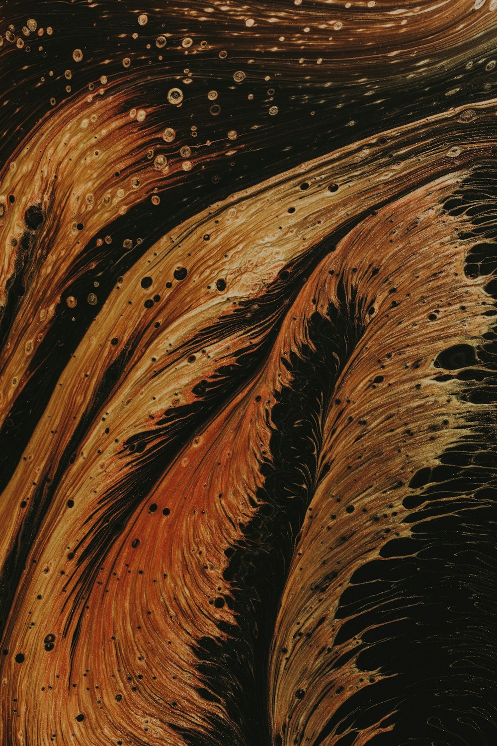 a close up of a brown and black painting