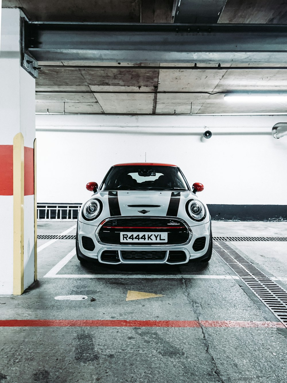 a white and black car parked in a parking garage