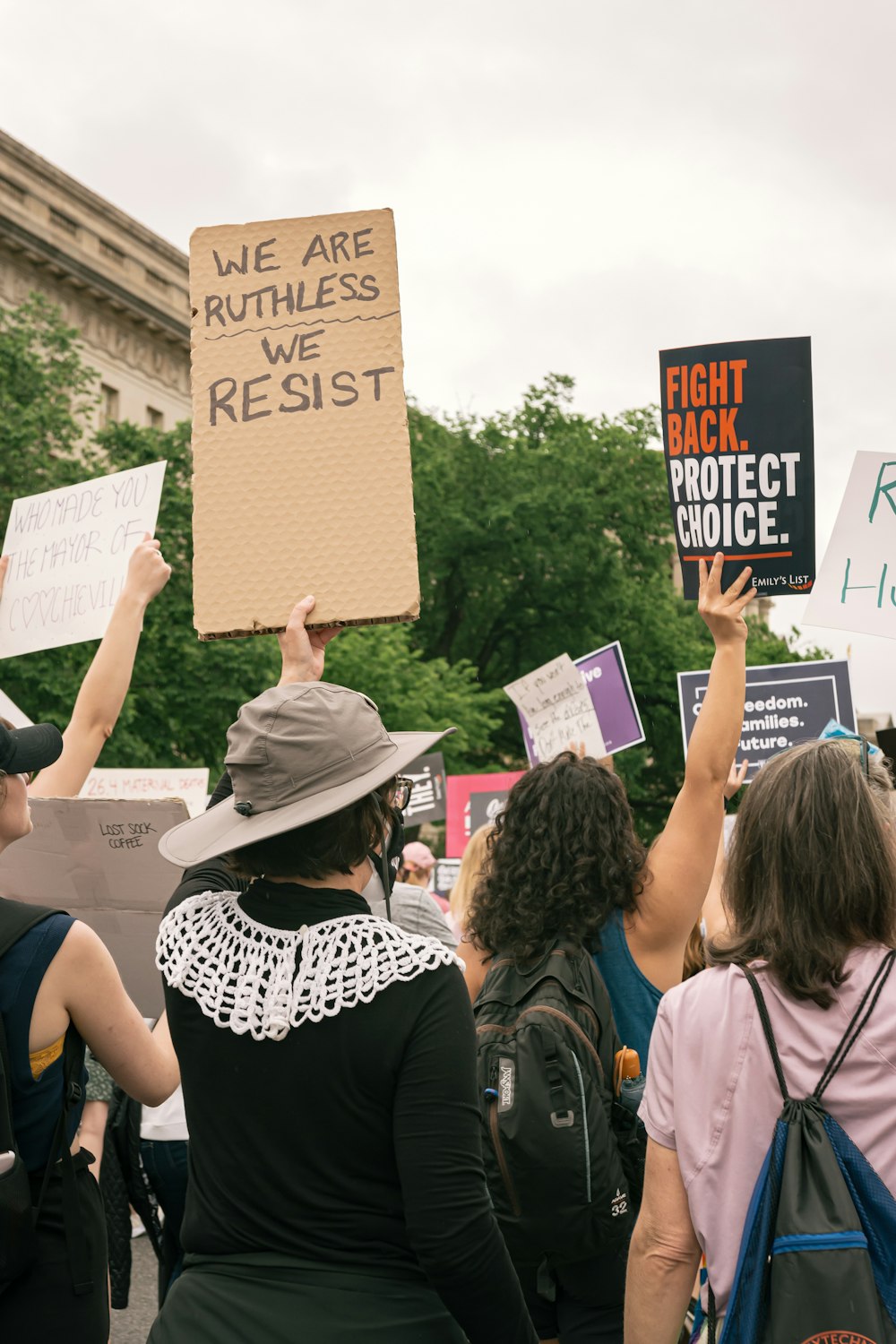 a group of people holding signs in the air