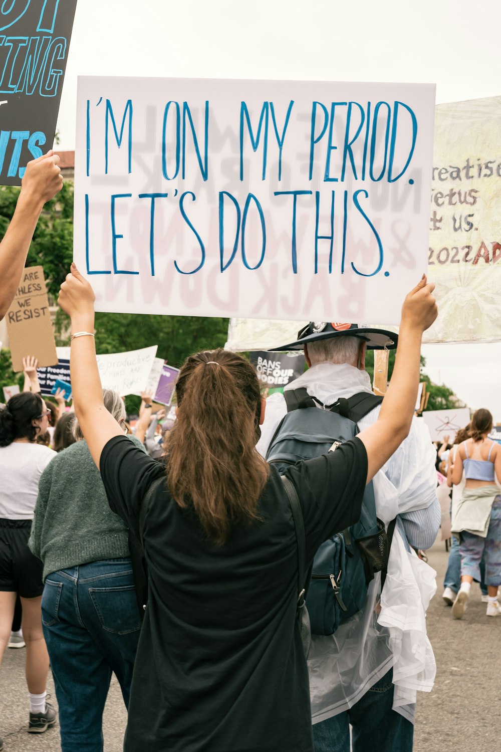 a group of people holding signs in the street