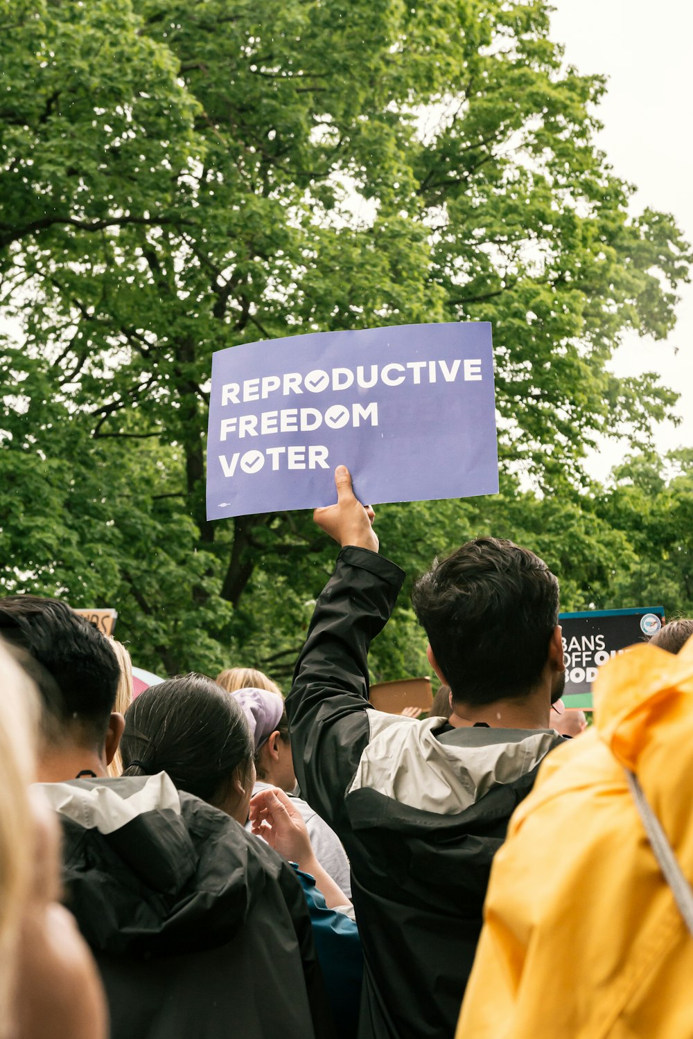 a group of people holding up a sign