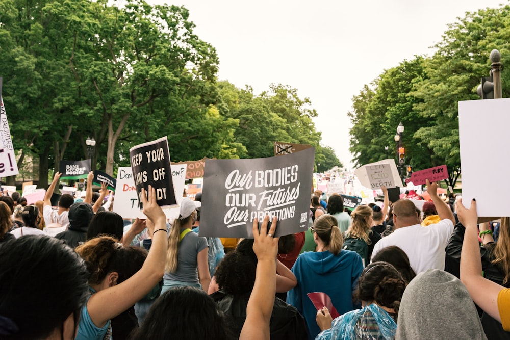 a large group of people holding up signs