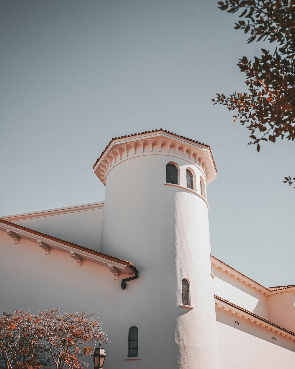 a tall white building with a clock on it's side