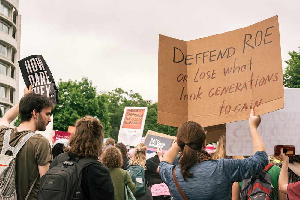 a group of people holding up signs in the air