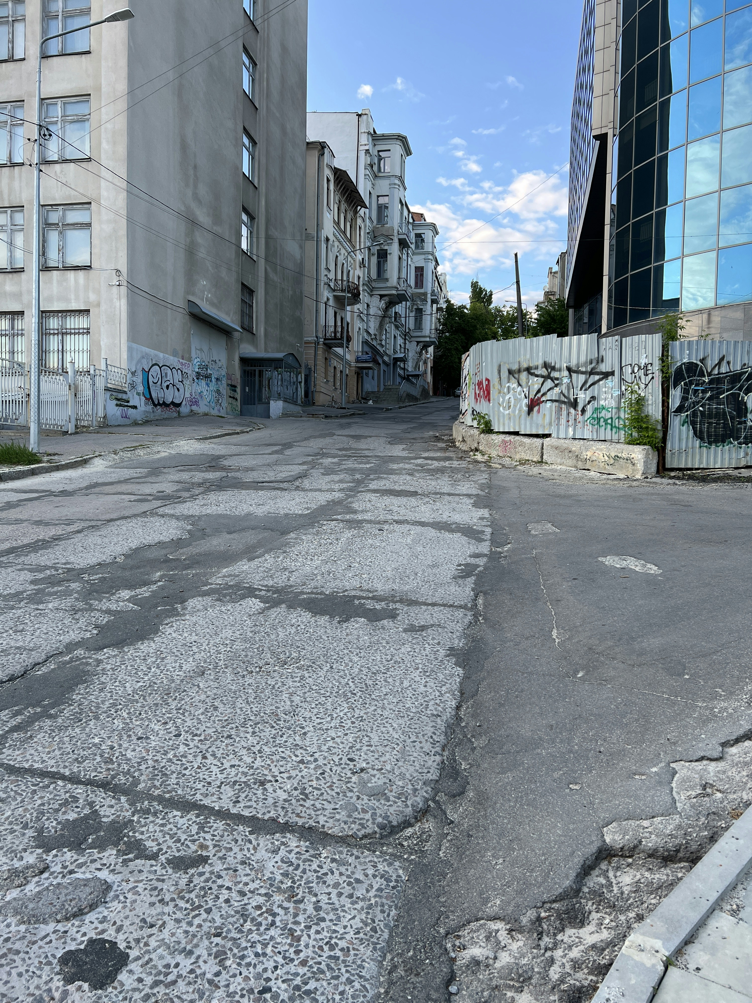 an empty street with graffiti on the buildings