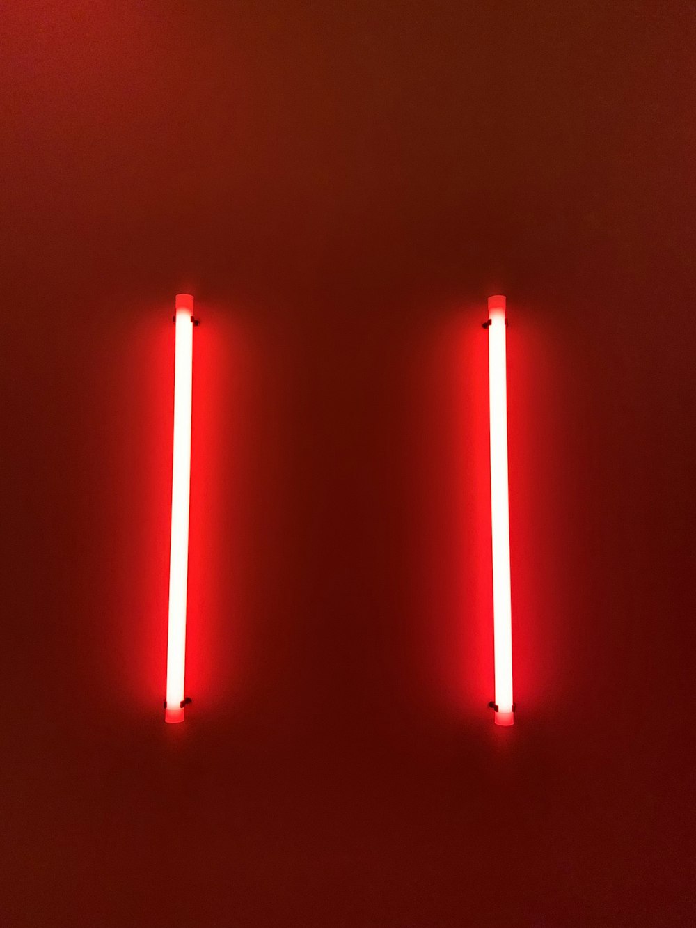 two red lights on a wall in a room