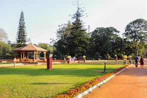 a park with a gazebo and people walking around