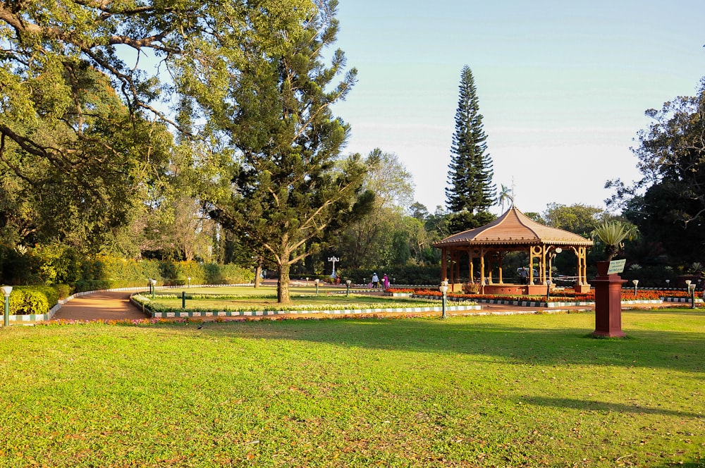a gazebo in the middle of a grassy park