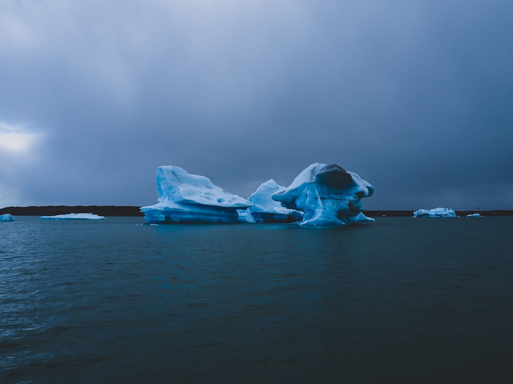 a large iceberg floating on top of a body of water