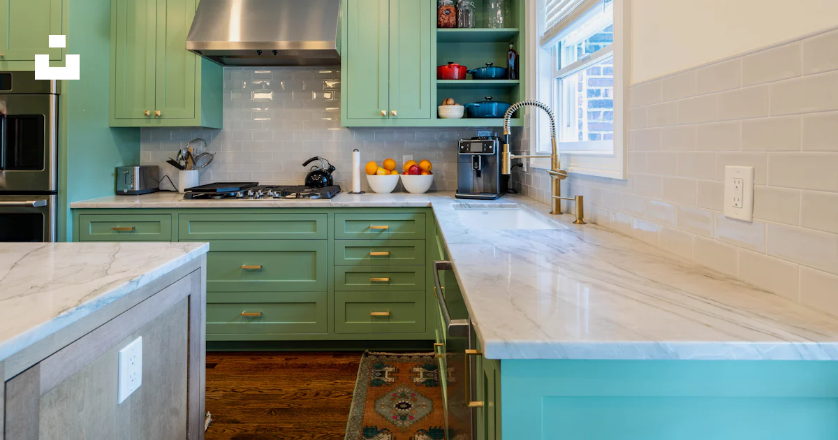 A kitchen with green cabinets and marble counter tops photo – Free ...