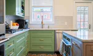 Close-up of elegant kitchen cabinetry with subtle green accents.