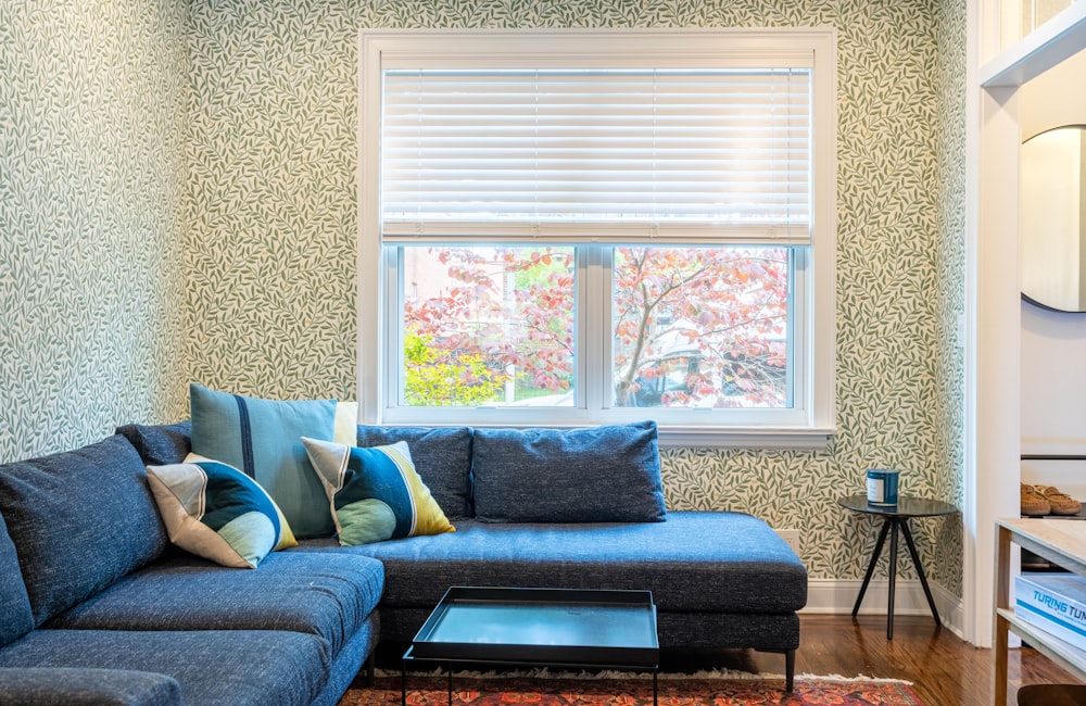 a living room with a blue couch and a coffee table