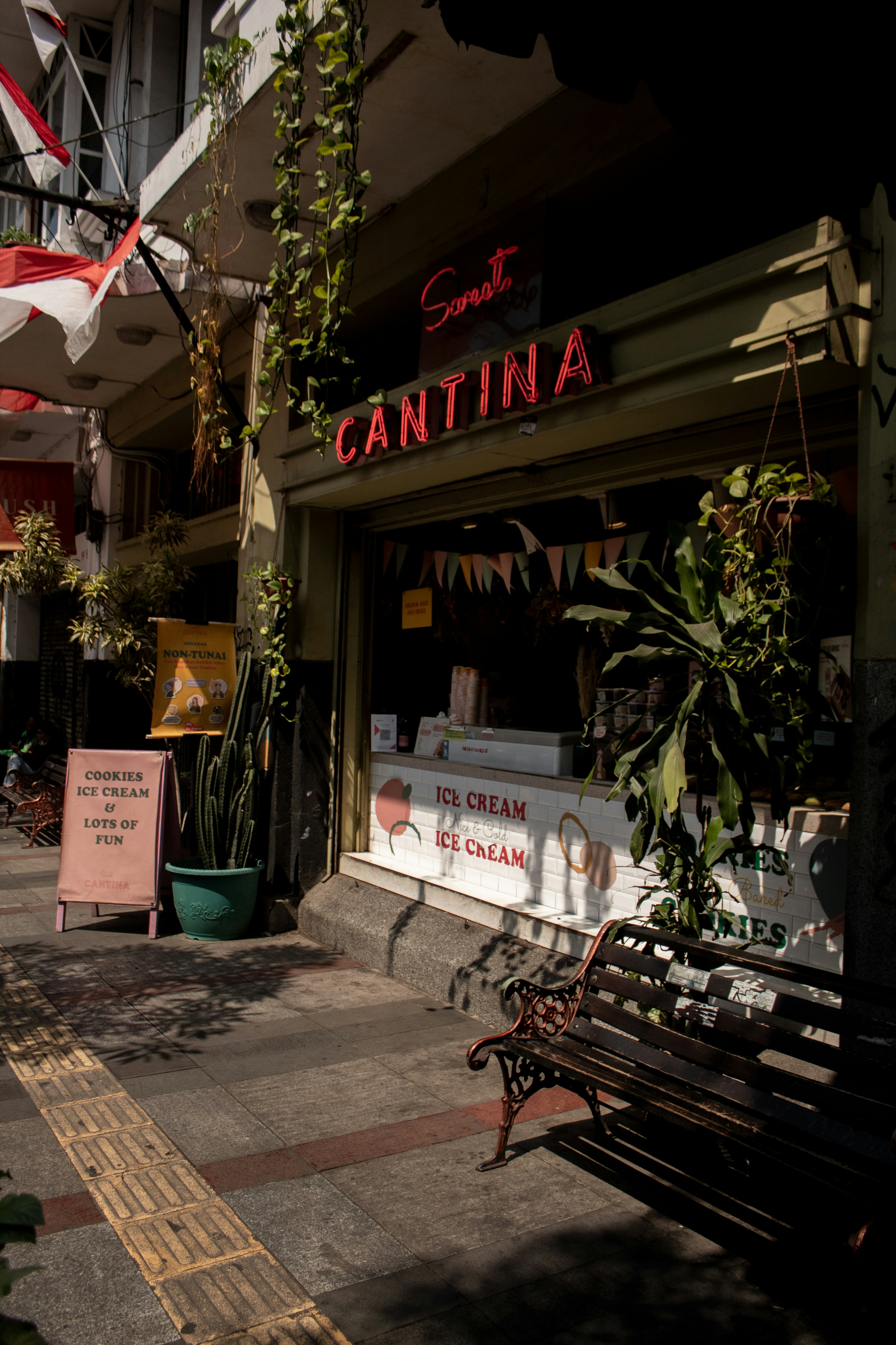 a bench on a sidewalk in front of a store