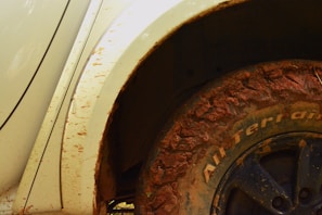 Close-up of mud-splattered tires on an ATV after an adventurous ride.
