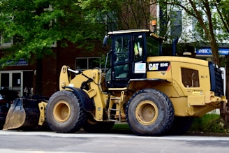 a yellow bulldozer parked on the side of the road