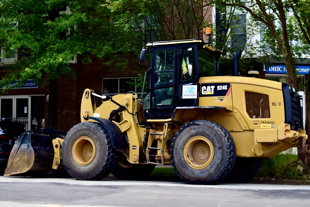 a yellow bulldozer parked on the side of the road