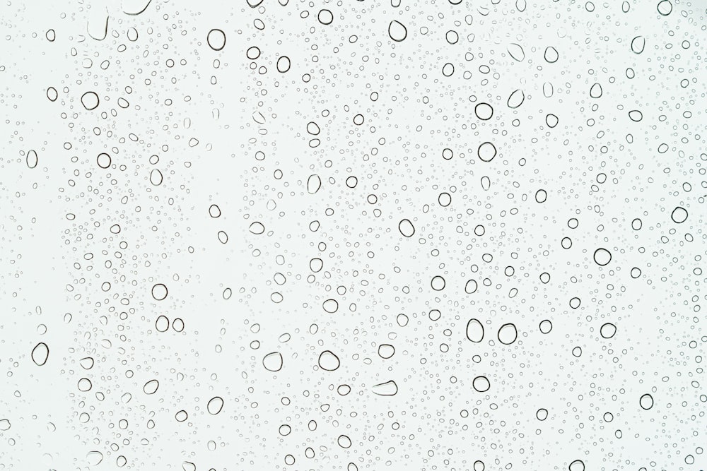 a close up of a window with rain drops