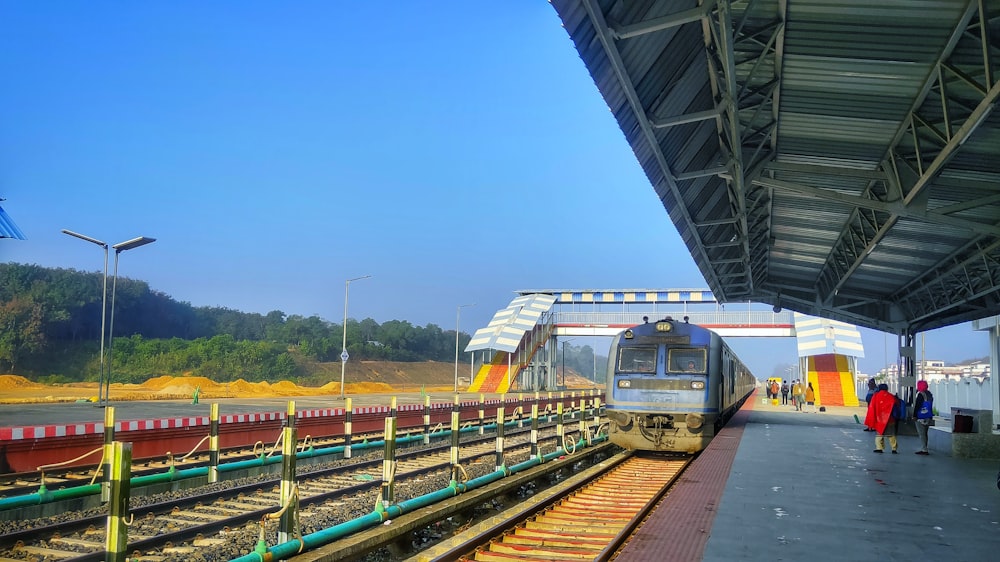 a train pulling into a train station next to a platform