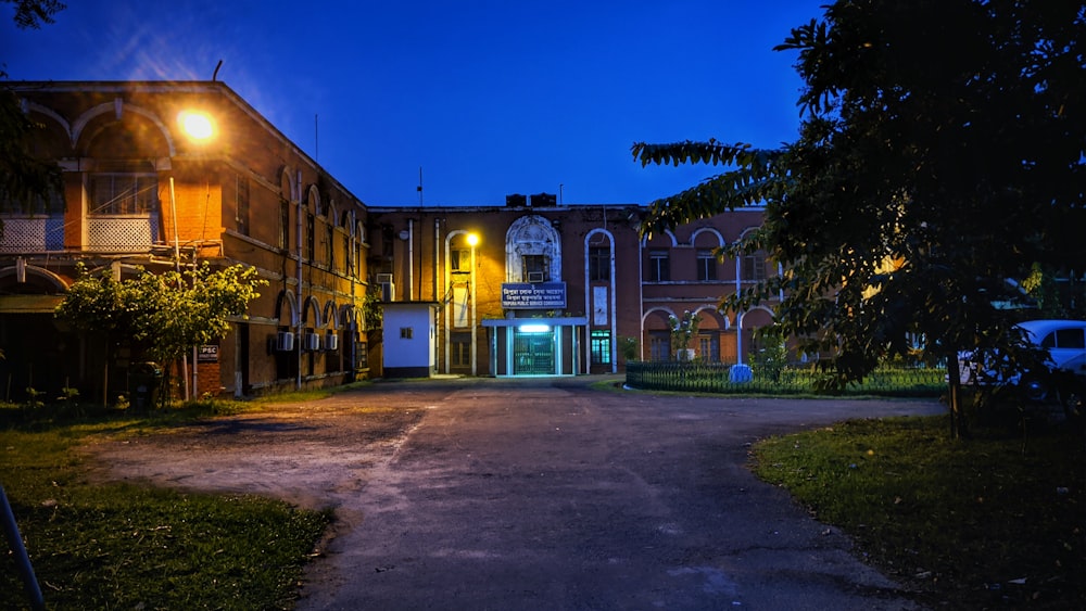an empty street in front of a building at night