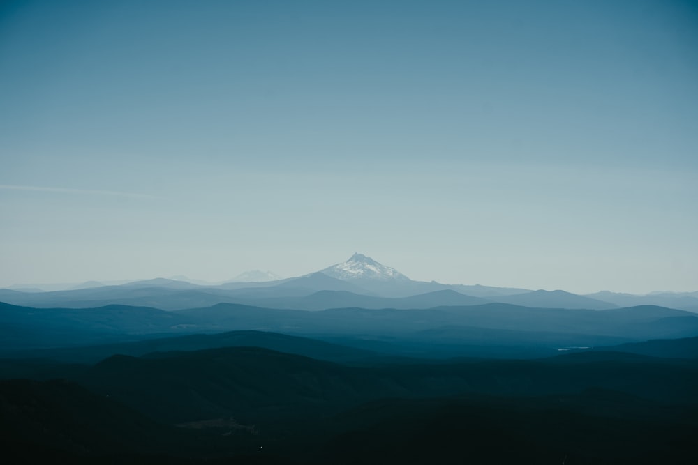 a view of a snow covered mountain from a distance