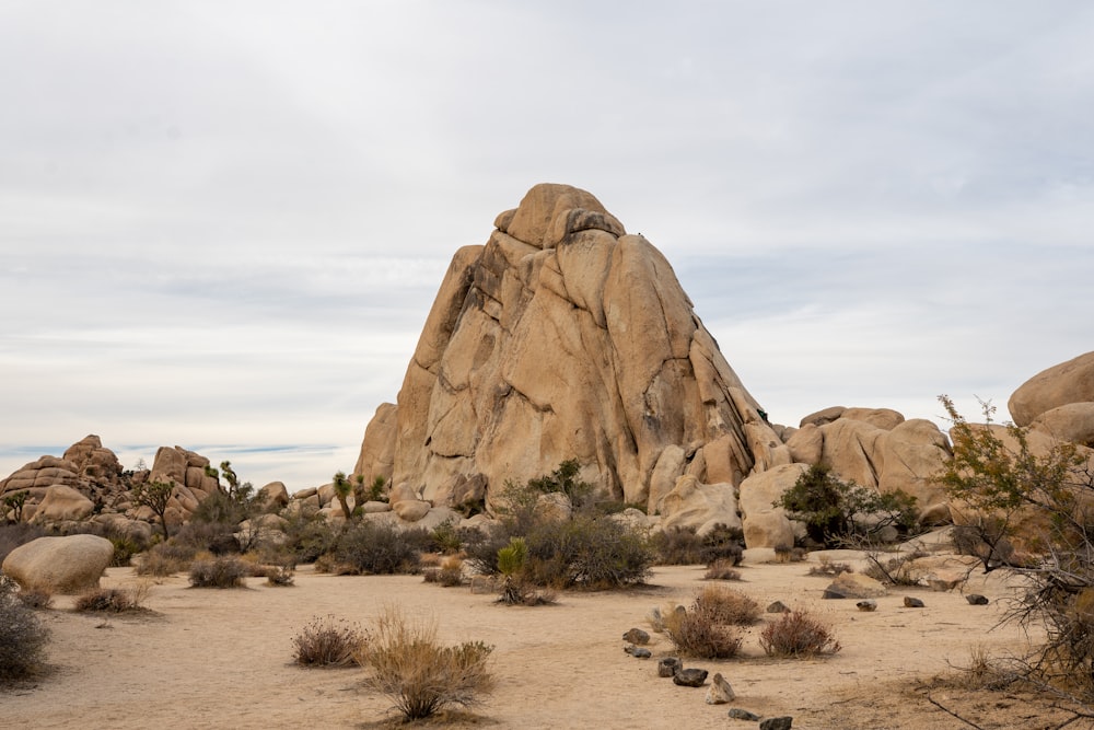 a large rock formation in the middle of a desert