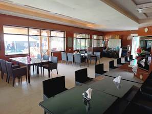 Communal kitchen area with stainless steel appliances and dining tables