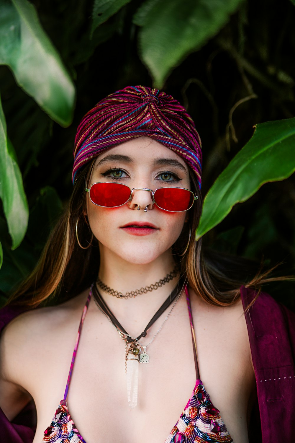 a woman wearing red glasses and a bandana