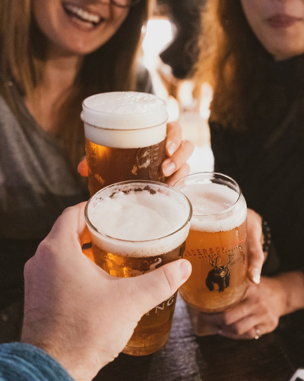 a couple of people that are holding some beers