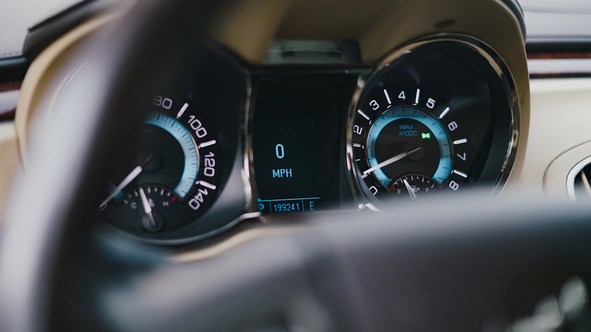 a car dashboard with a speedometer and other gauges