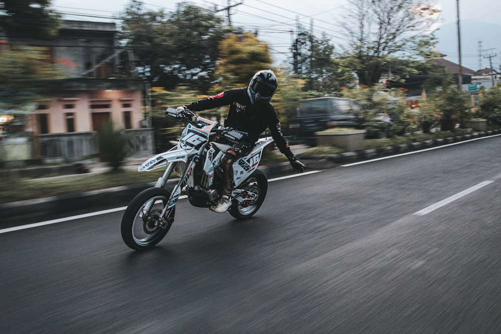 a person riding a motorcycle down a street