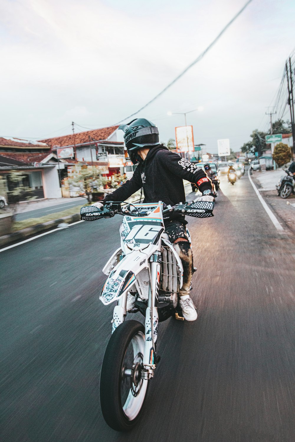 a person riding a motorcycle down a street