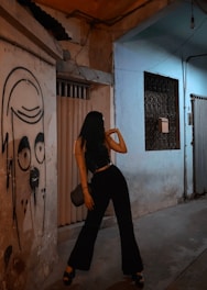 An edgy street portrait under stark lighting against a graffiti-covered wall in nighttime cityscape.