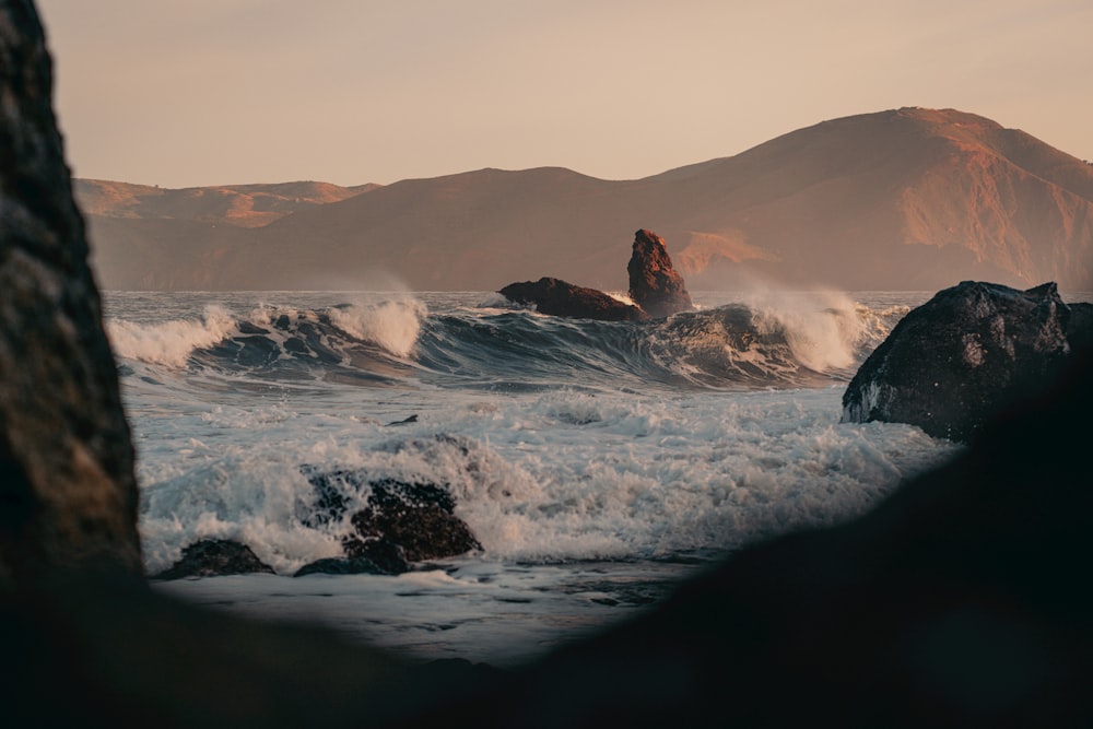 a body of water surrounded by mountains and rocks