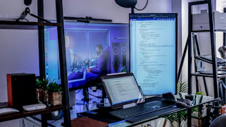 a desk with a laptop and a monitor on it