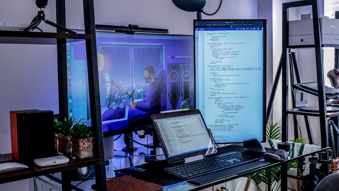 a desk with a laptop and a monitor on it, Data scientist