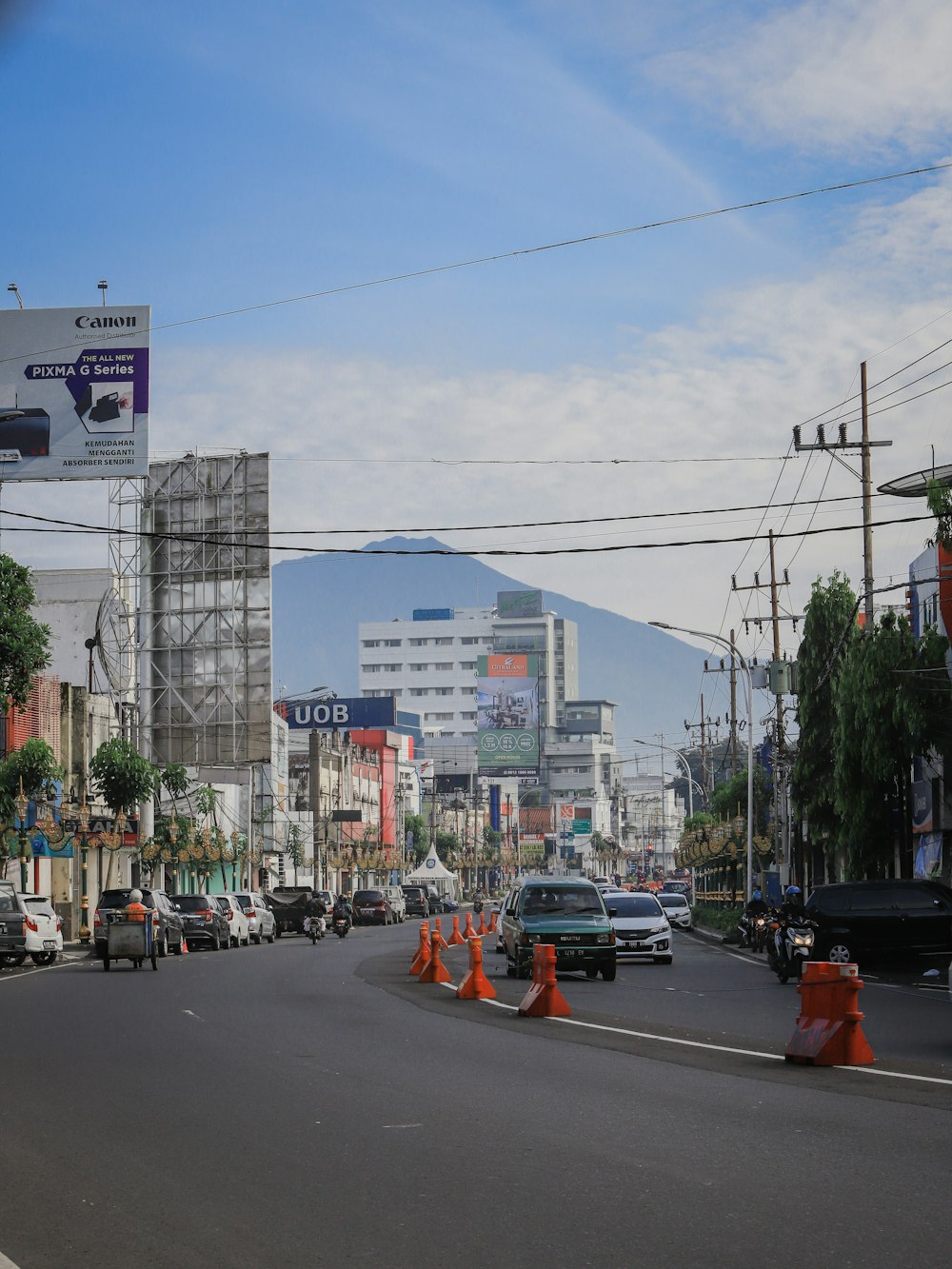 a city street filled with traffic next to tall buildings