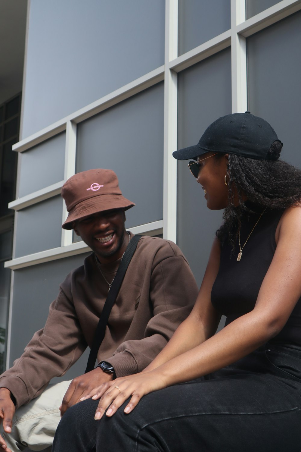 a man sitting next to a woman on a bench