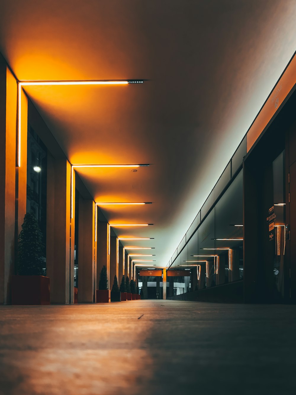 a long hallway with several lights on either side of it