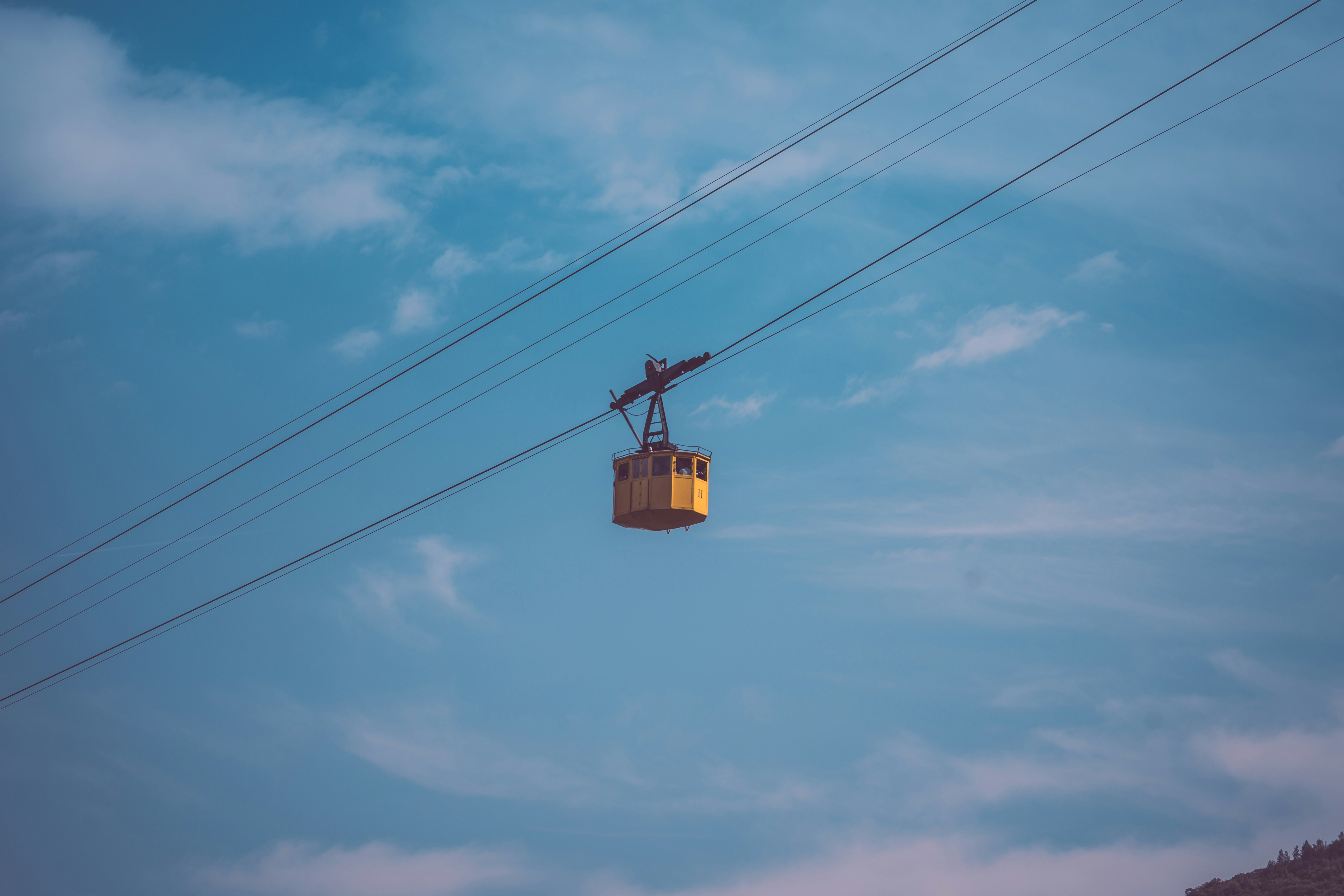 a stop light that is hanging on a cloudy day, 