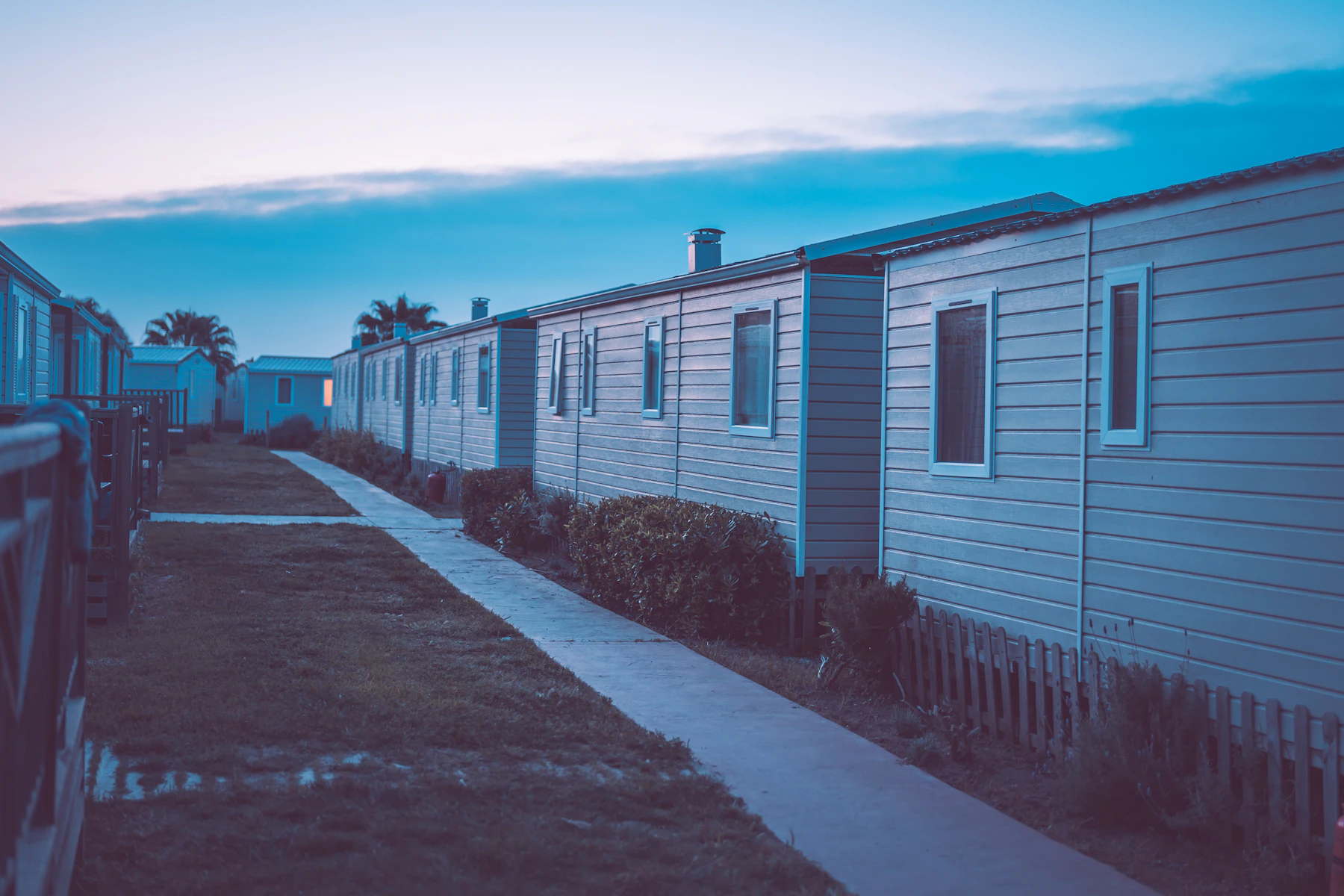 Row of mobile homes in a residential community illustrating mobile home park tax benefits and depreciation planning