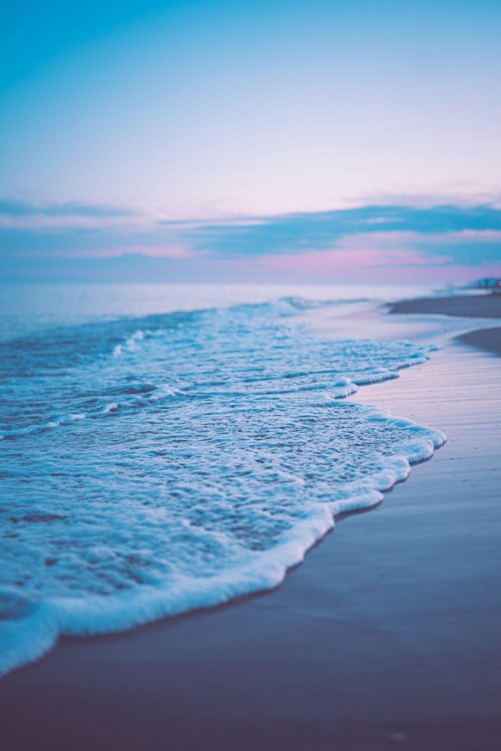 a beach with waves coming in to the shore