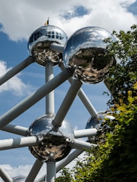 a large metal structure with mirrored balls on top of it