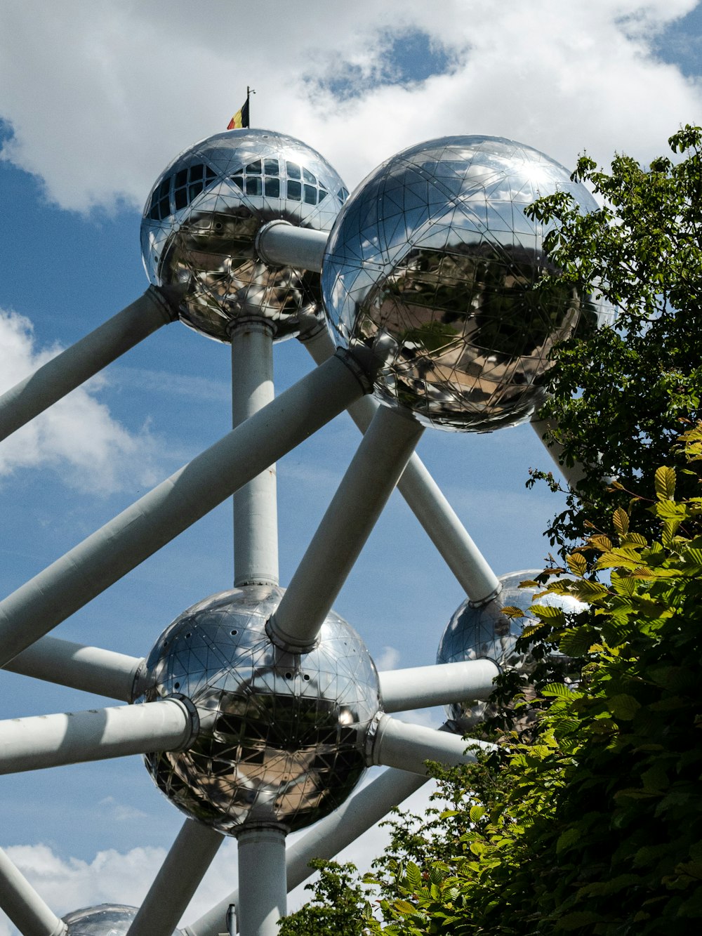 a large metal structure with mirrored balls on top of it