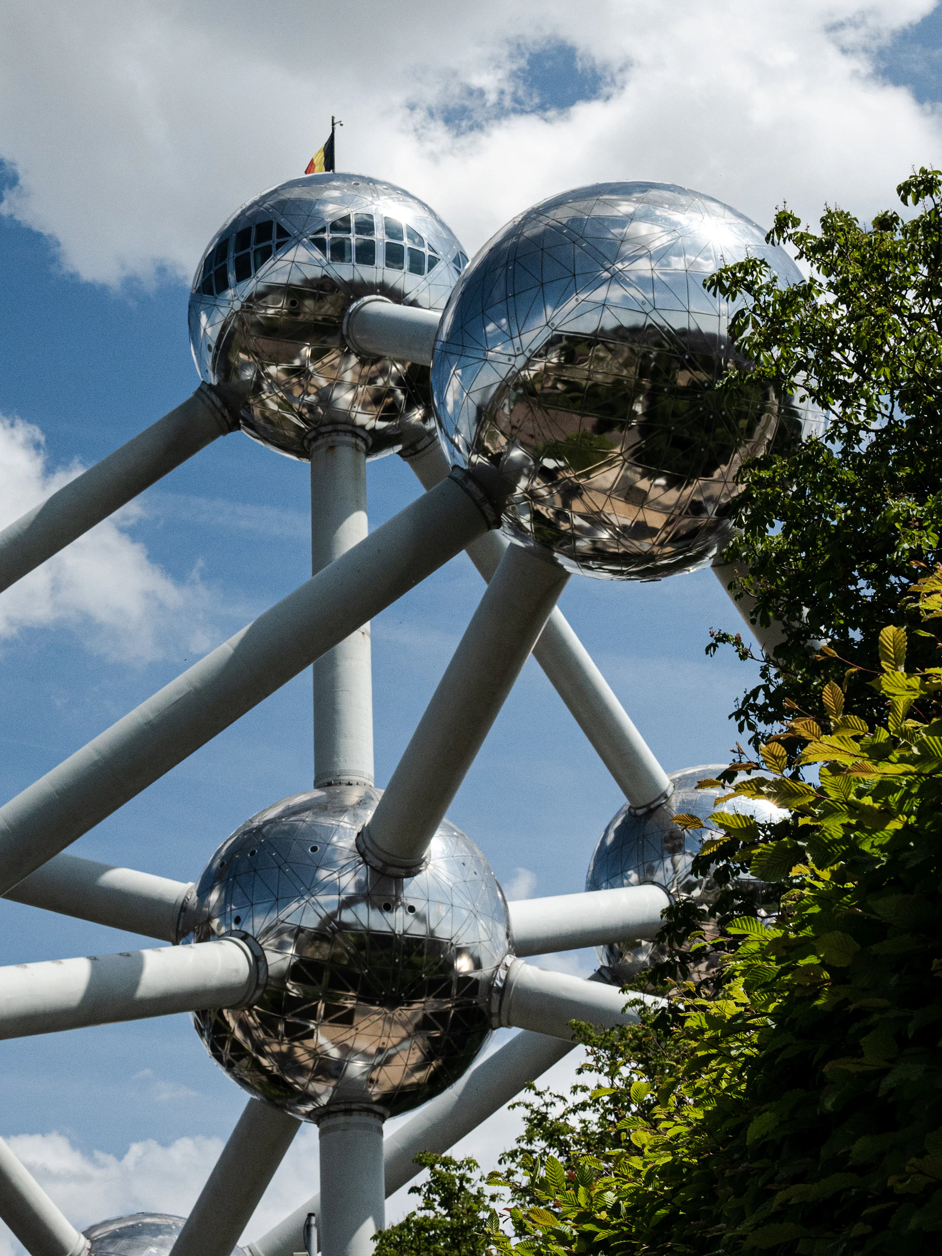 a large metal structure with mirrored balls on top of it