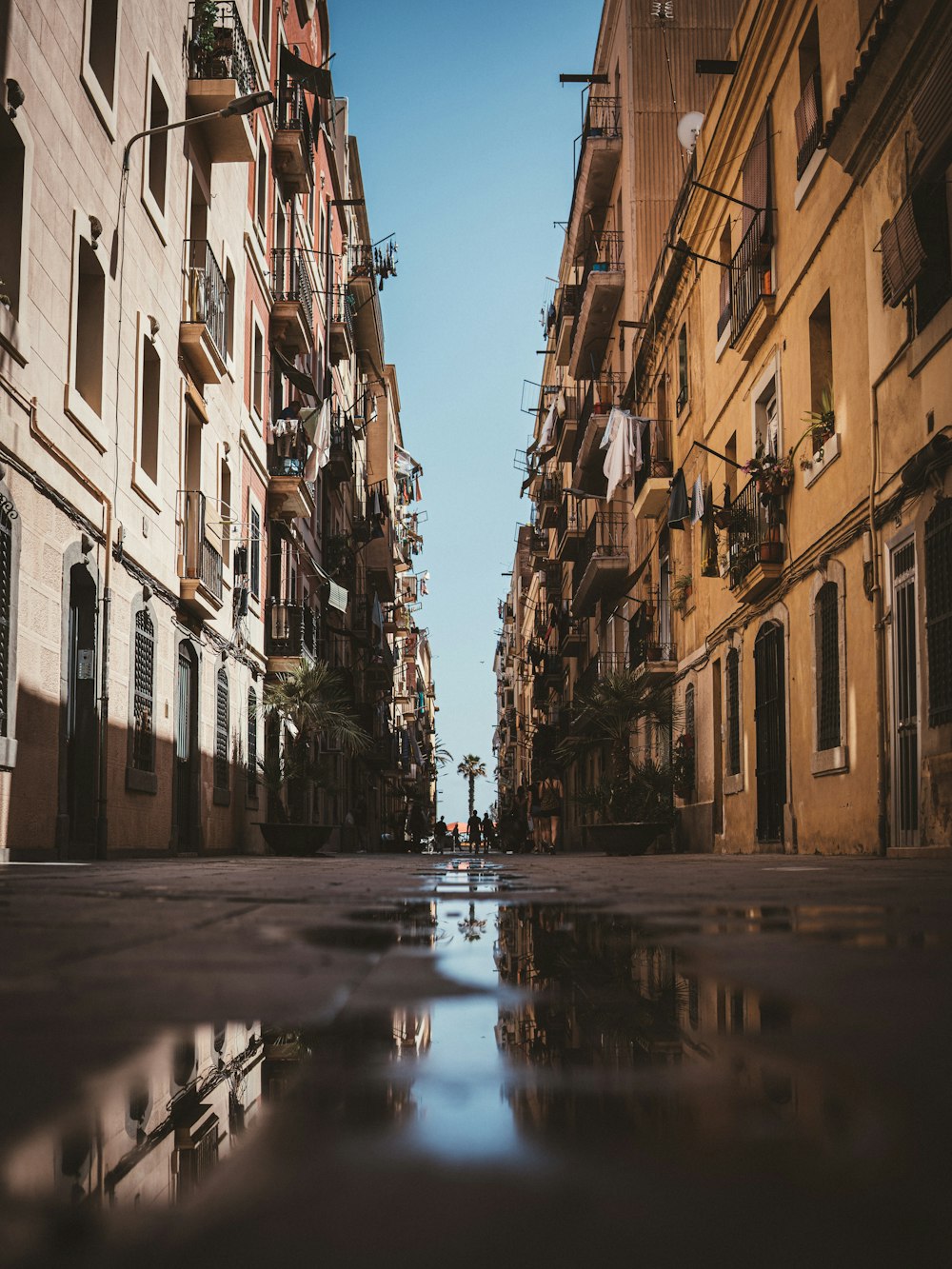 a city street with a puddle in the middle of it