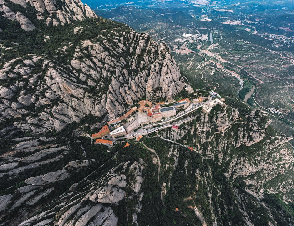 an aerial view of a castle on a mountain