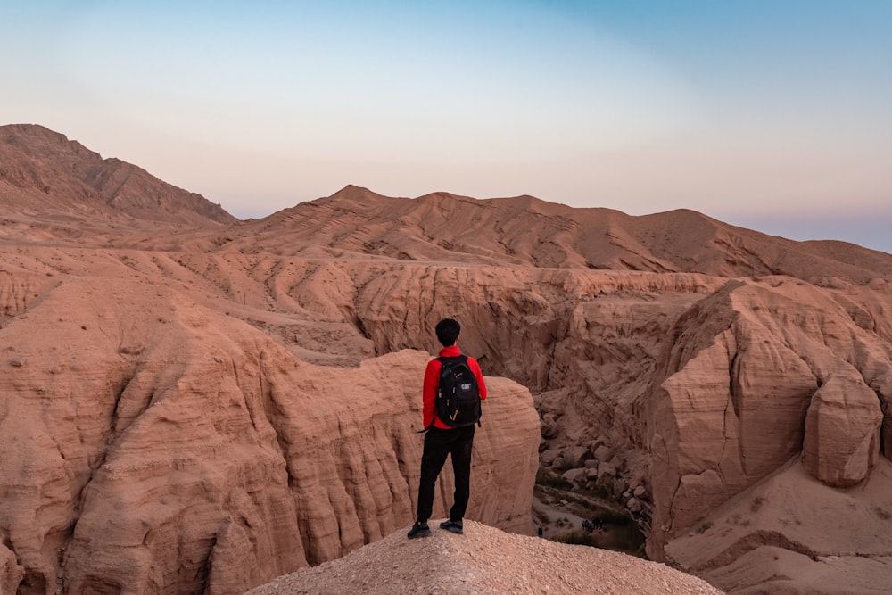 a man standing on top of a rock formation