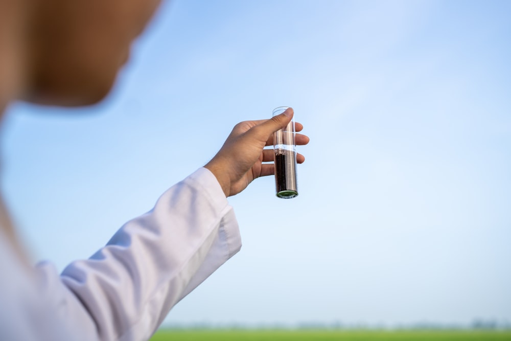 a person holding a bottle of alcohol in their hand